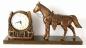 Cheval et horloge  fer  cheval , fini cuivr, avec base en bois fonc (mcanisme remontable)