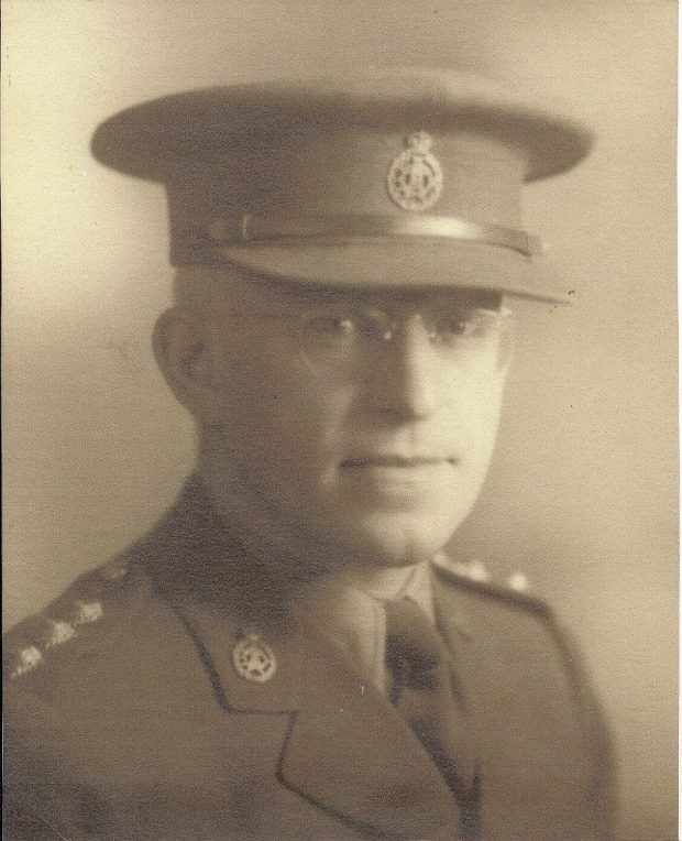 Portrait officiel d’un homme portant des lunettes à monture métallique et l’uniforme de l’Armée canadienne sur lequel on voit une épinglette du Corps dentaire royal canadien.