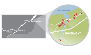 Carte en noir et blanc d'une partie du Québec situant les principales villes. Un agrandissement en couleur dans un cercle montre Montmagny.