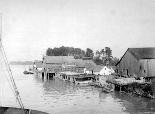  plusieurs bâtiments en bois de tailles et de hauteurs différentes sur les quais de la rive