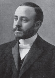 Photographie en noir et blanc datant du début du 20e siècle d’un homme portant une courte barbe et portant un complet. Rabbin Herman Abramowitz.