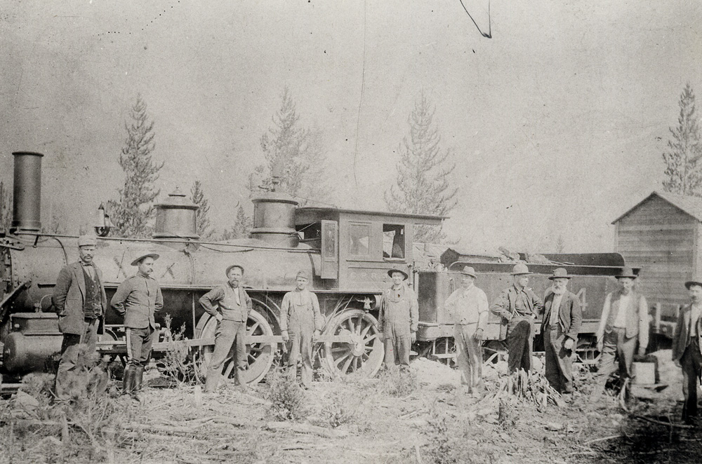 Photographie d'une locomotive avec une voiture à charbon derrière elle.