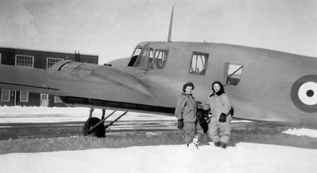 Two women in front of airplane