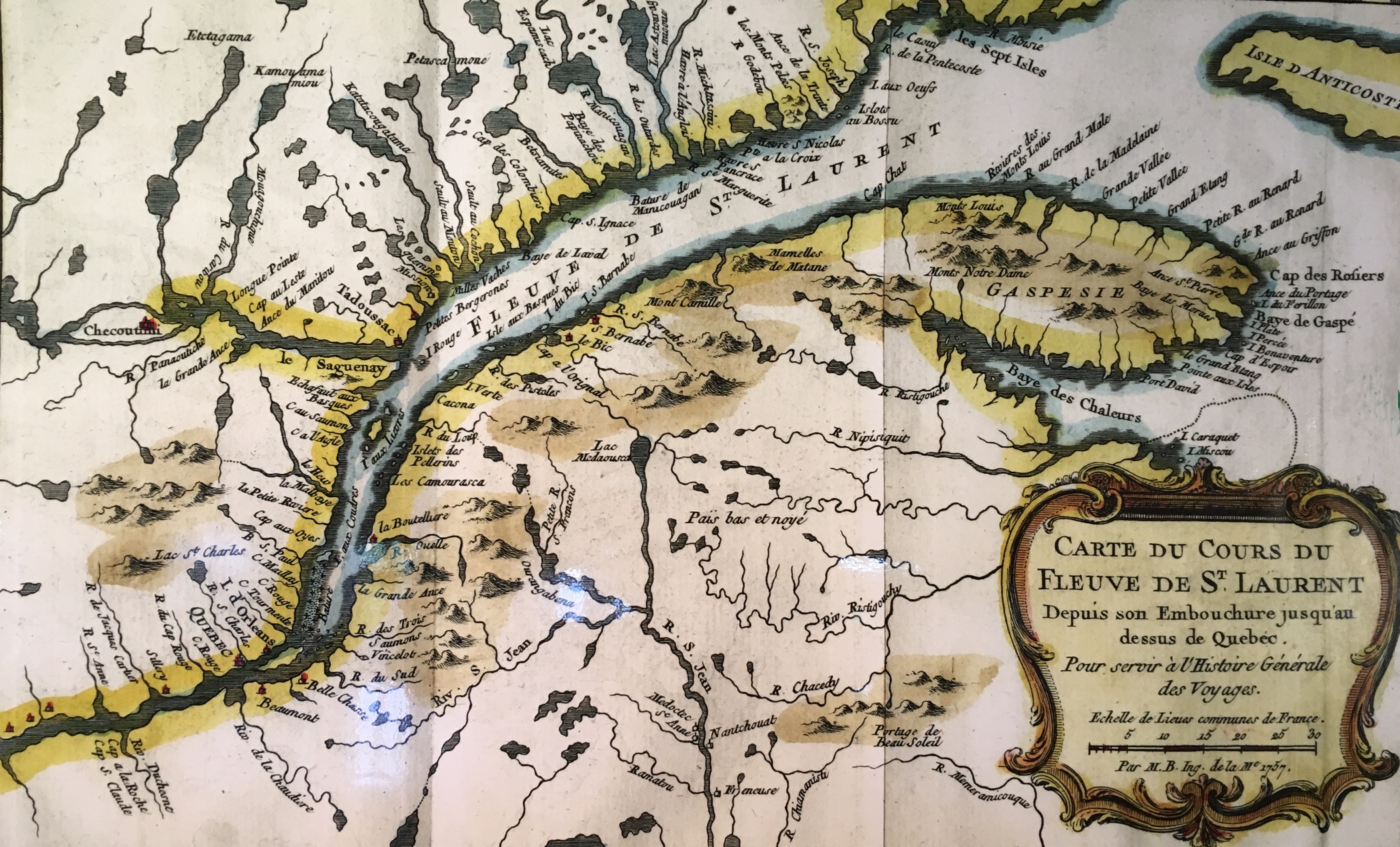 Photo couleur d'une carte géographique représentant le golfe du Saint-Laurent aux abords de la Gaspésie, s’étendant jusqu'à la ville de Québec. En bordure du fleuve, on aperçoit des terres traversées par des lacs et des rivières de plus petite étendue. 