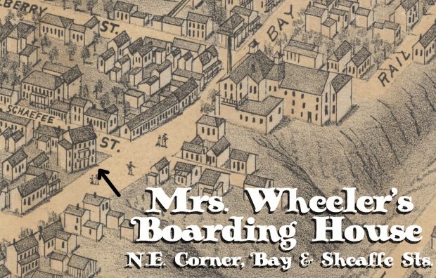 Carte illustrée montrant une partie de la ville d’Hamilton au milieu du XIXe siècle. On peut voir sur la carte illustrée des maisons et d’autres structures, ainsi qu’une colline escarpée sur la droite de l’image. Un immeuble de trois étages à l’angle nord-est des rues Bay et Sheaffe est identifié comme la maison de pension de Mme Wheeler.