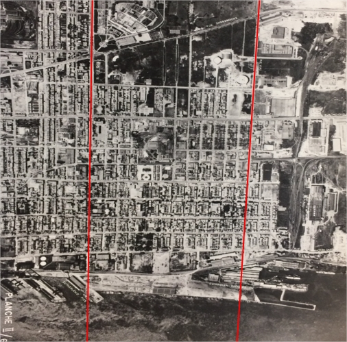 Une photographie aérienne d'une partie de la ville de Montréal densément peuplée avec deux lignes rouges