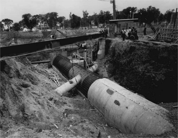 Un égout en déconstruction dans une tranchée avec des ouvriers