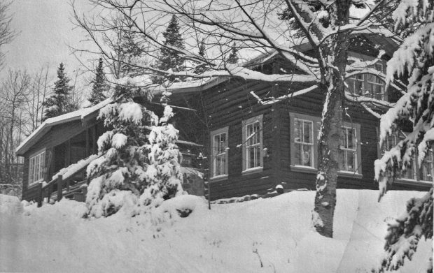 Scène d’hiver des années 1950 montrant l’auberge Le Rouet, à l’époque un petit chalet de bois rond.