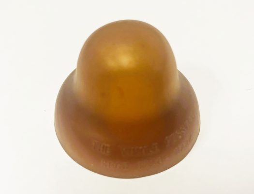 Brown hat-shaped object on a white surface.