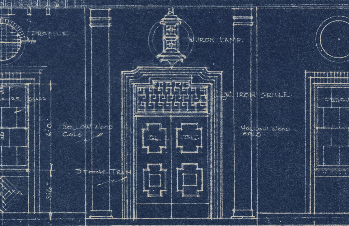 <span style="font-weight: 400;">Close-up of blue-and-white hand-drawn architectural plans, depicting a Chinese-style wrought iron lamp above a wooden door with iron grille and stone trim.</span>